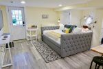 Charming tufted queen bed, pulls out to reveal an additional twin mattress